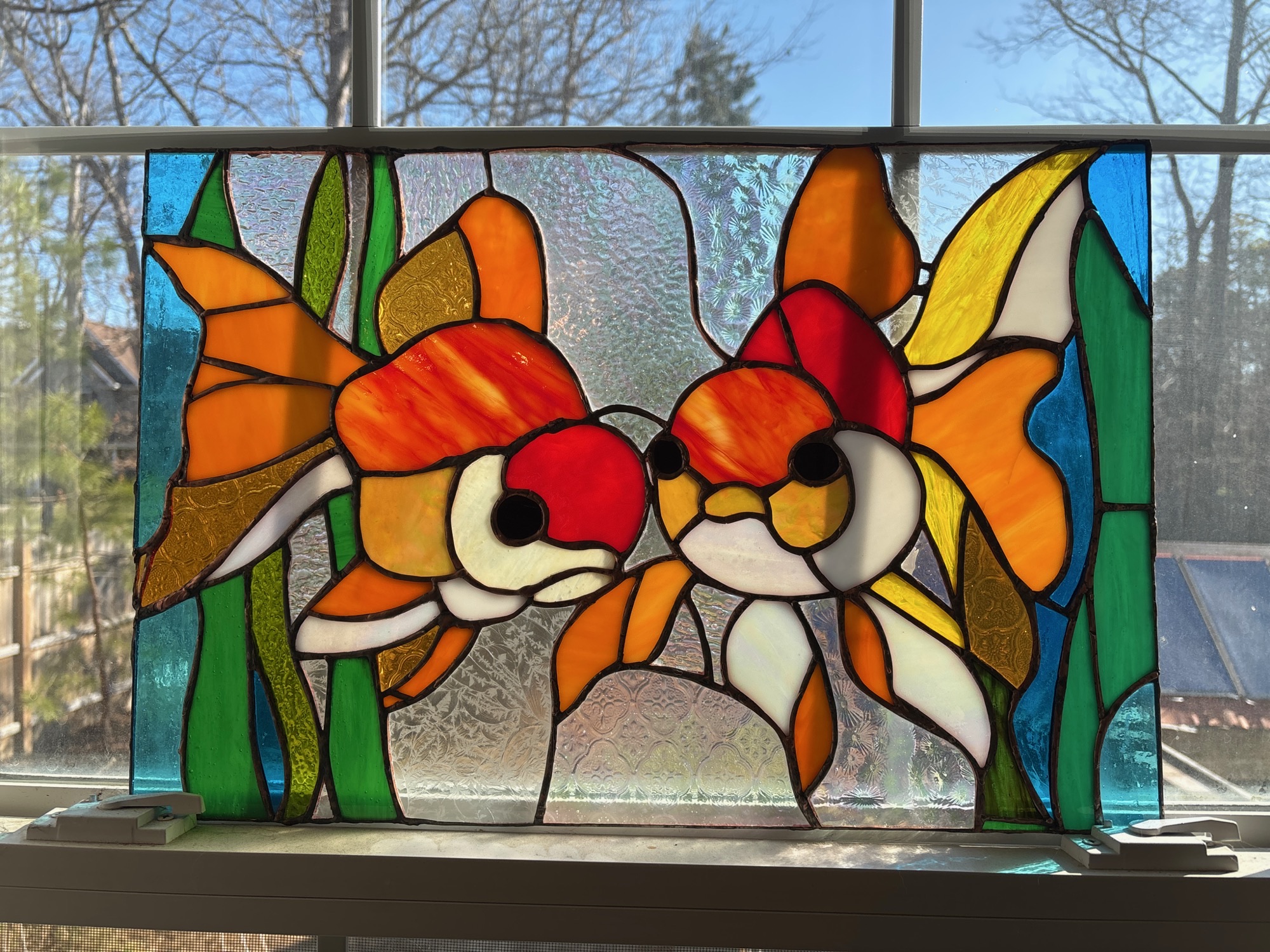 Three rose panels on a windowsill
